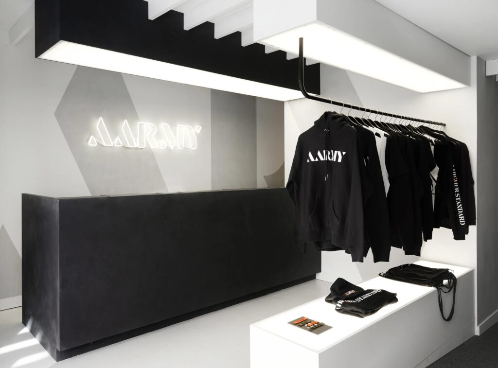 Photo of a small merchandise area with downlighting at the AARMY popup fitness studio