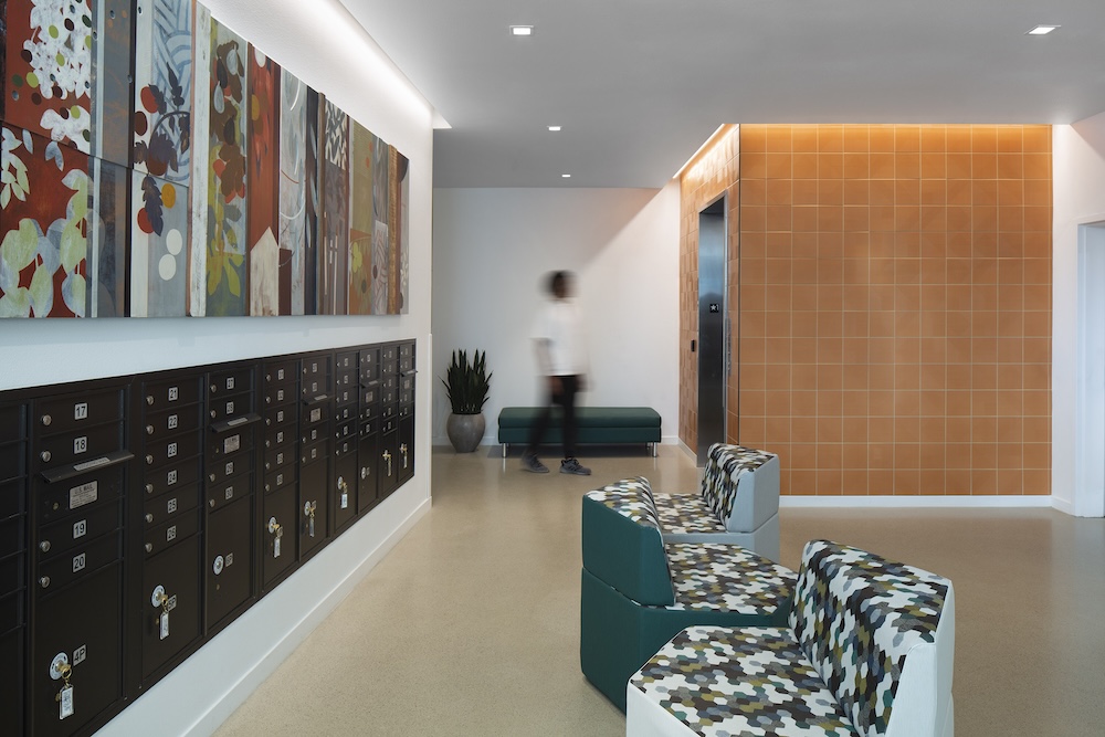 Cove lights illuminate mailboxes and the elevator in the Wilton Court Apartments lobby 